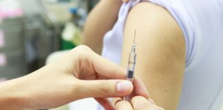 Why are vaccination rates in England falling?